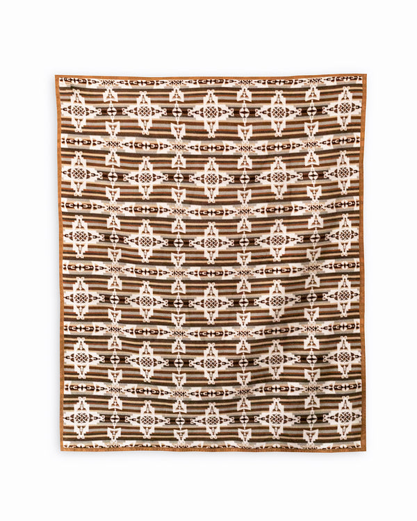 Reverse side of mother and child brown blanket. Brown and beige stripes on the background, on top are repeated geometric white mother and child symbols in a shape of a cross