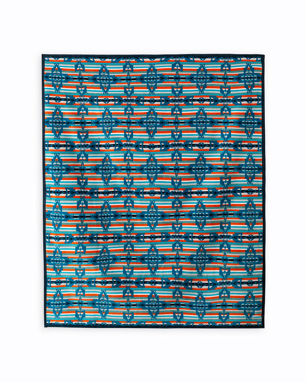 Reverse of the blanket is a stripe background made out of light blue, orange and white stripes, the crosses are in dark blue, repeated horizontally and vertically