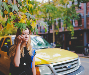 A girl walking in NY City, yellow cab 