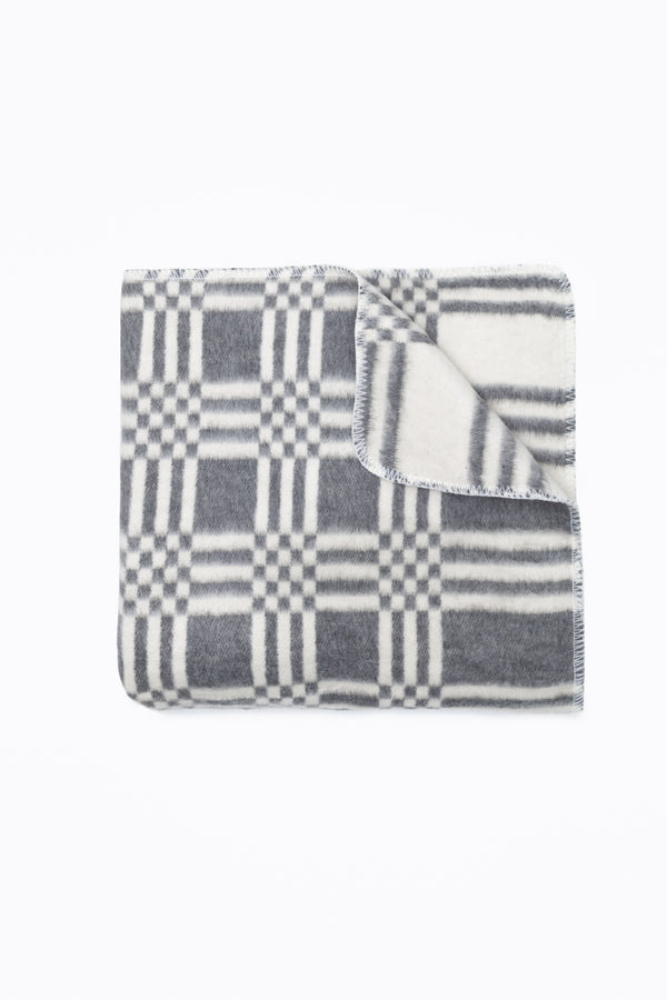 Grey and white folded reversible blanket 