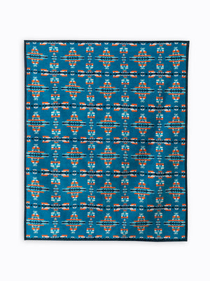 Blue background with a cross made out of celtic mother child symbols with orange and while and light blue stripes in a repeat pattern