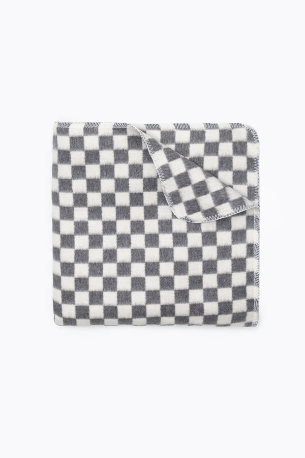 Folded grey and white checkers blanket