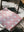 Folded red and white blanket folded on a deck chair summer light and tree shades falling around the chair